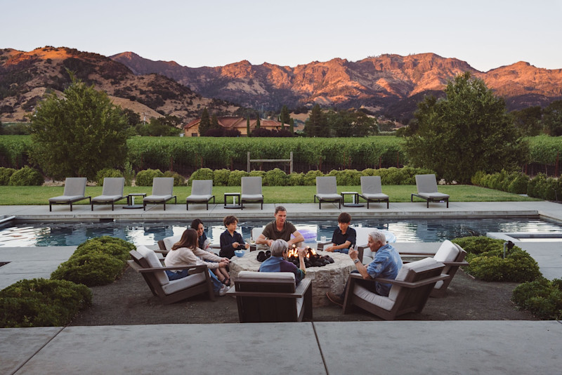 Pacaso owners gathered around a firepit at dusk